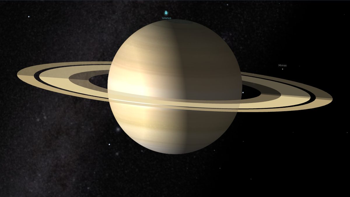Saturn and its rings seen from a low angle in the NowSky orbit view, with a few of its moons nearby